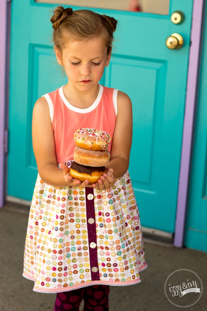 1_caf-fiend-donut-dress_holding-stack-of-donuts
